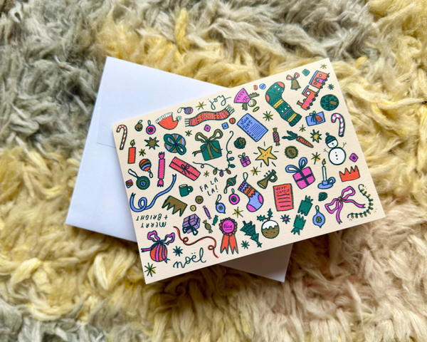 Christmas card with colourful designs on a textured surface